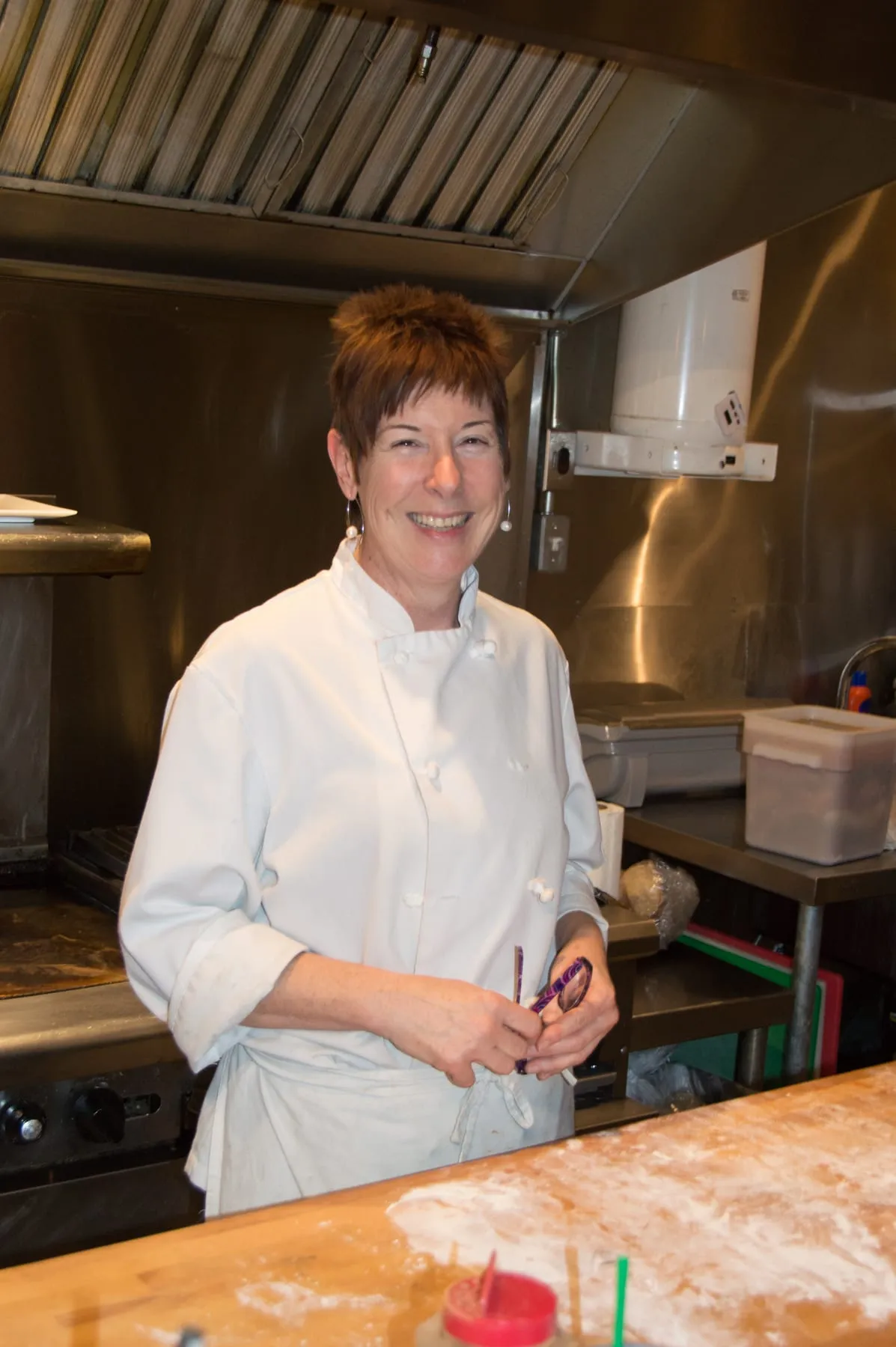 Jan in the kitchen, finishing a plate