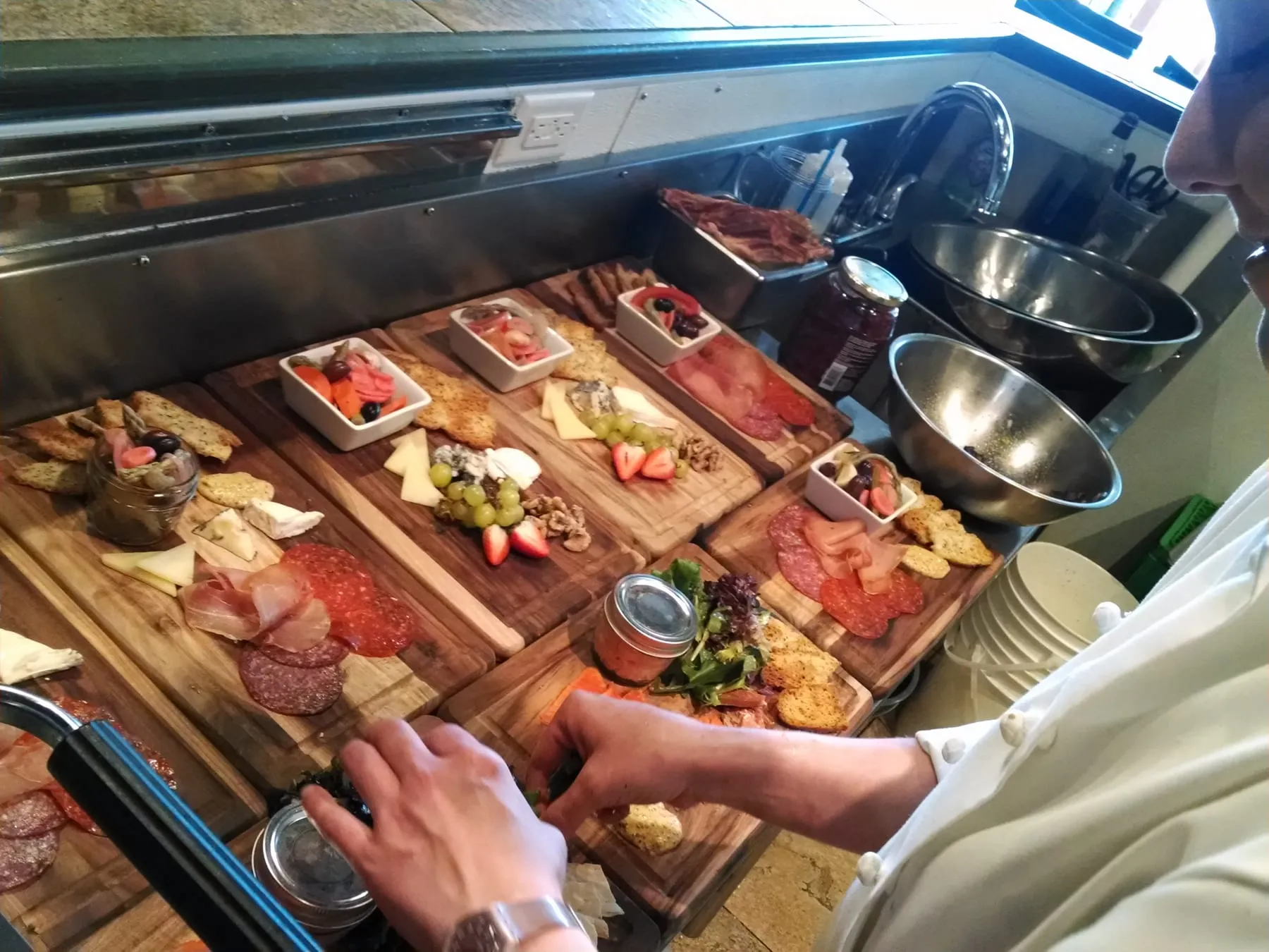 Charcuterie boards being built along the pass