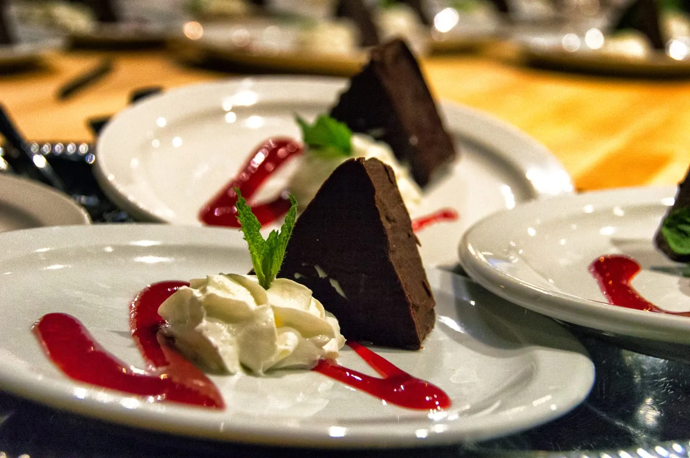 A chocolate pâté dessert plated for a wedding dinner