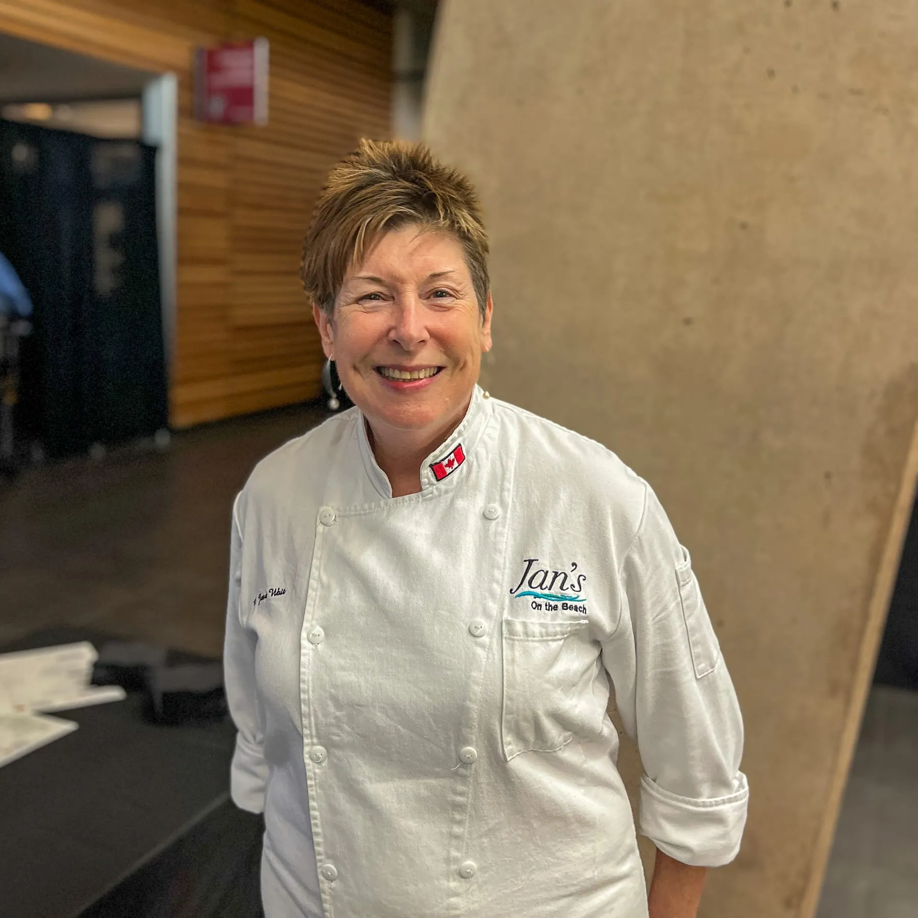 Chef Janet Wait plating a course in her whites