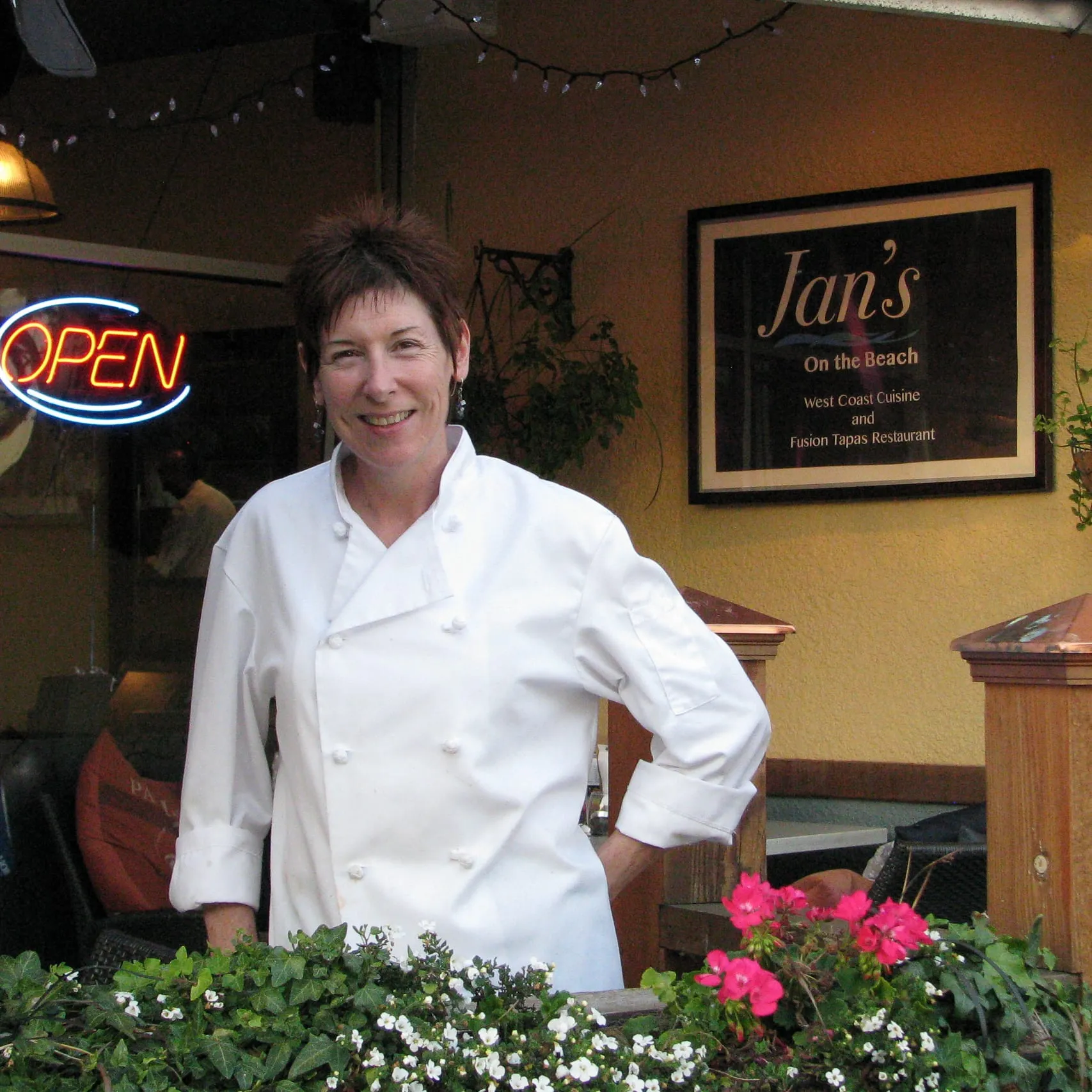 Chef Janet Wait in her chef's whites outside Jan's on the Beach