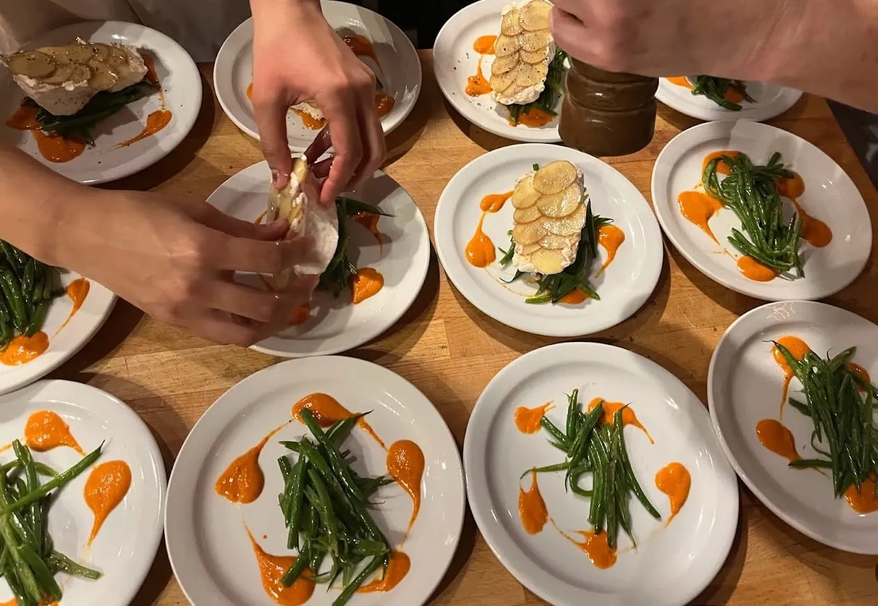 Plates finished with green beans and romesco