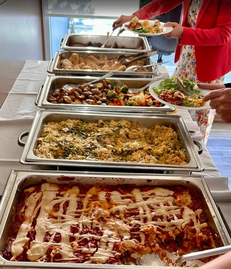 A buffet line of chafing dishes at an office lunch